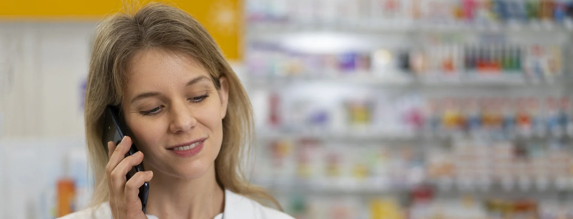 A pharmacy team member preparing to speak with a patient